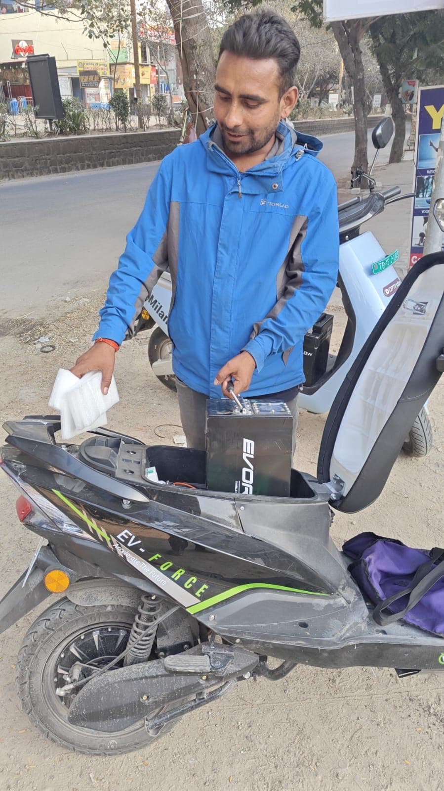 EVORA team member swapping battery on EV scooter